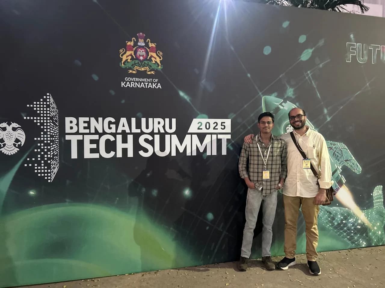 Standing in front of the Government of Karnataka Bengaluru Tech Summit 2025 backdrop
